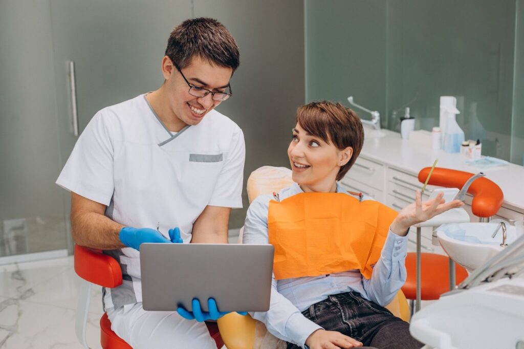 female patient sitting in a dentist's chair and receiving professional hygiene treatment