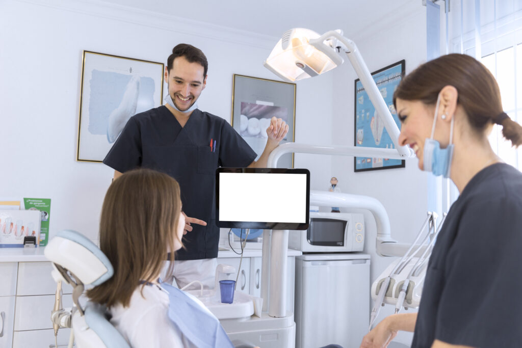 smiling patient and dentist having a conversation in a dental clinic